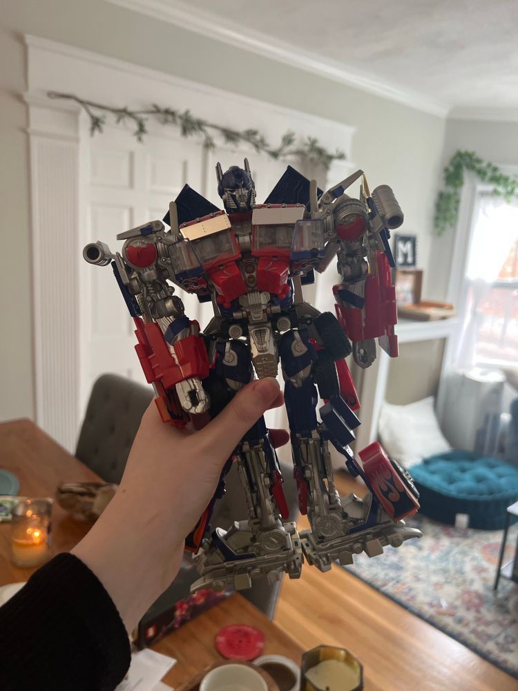 hand holding a japanese exclusive buster optimus prime