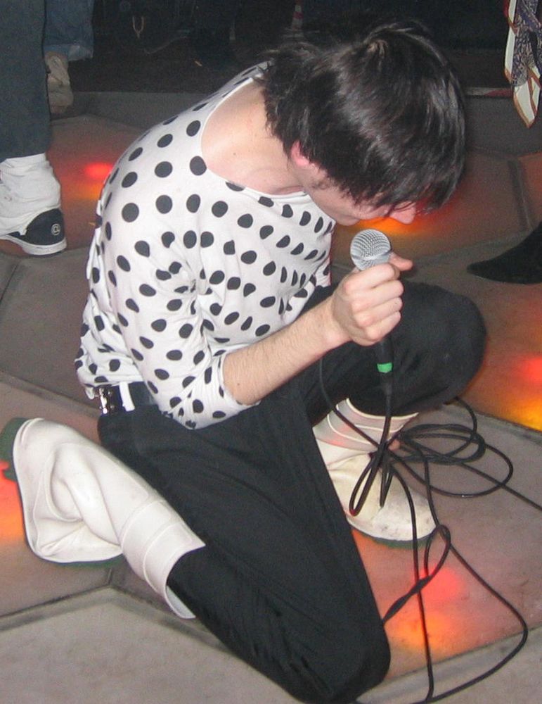 Me performing in 2004 on a light-up dancefloor in Kings Cross (?). Outfit: Black and white polka dot top / white safety boots.