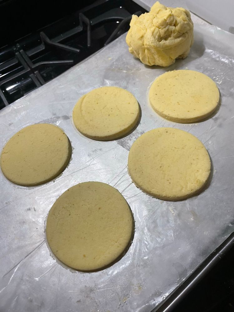 Rolled out my dough on wax paper on the bottom of a sheet pan and cut circles with a glass. 5 gluten free dough circles and a ball of leftover dough. 