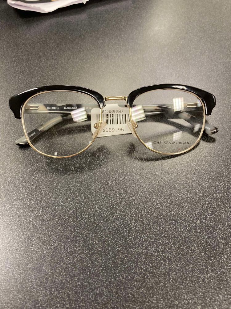 Black browline glasses. The metal part of the frame is gold.