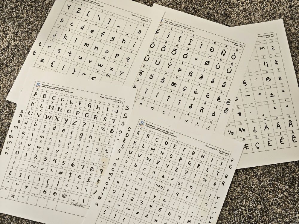 Several pieces of paper with a grid, with different letters and characters on them that I hand-wrote. I scanned in these to make a few different fonts!