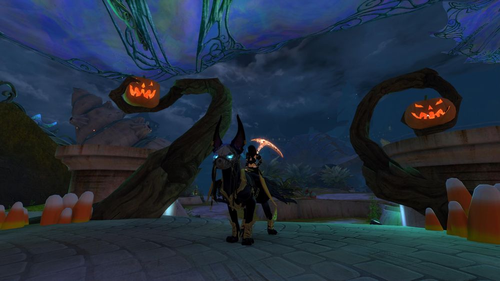 Skye sits on her gryphon in Lion's Arch framed by two twisted trees tipped with grinning jack-o'-lanterns. At the base of the trees are piles of candy corn.