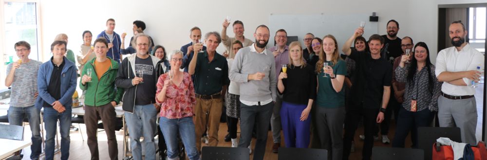 The members of the Cluster of Excellence "Machine Learning: New Perspectives for Science" raise their glasses and celebrate securing another funding period.