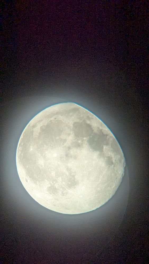 A photo of the moon taken through a 20mm telescope eyepiece