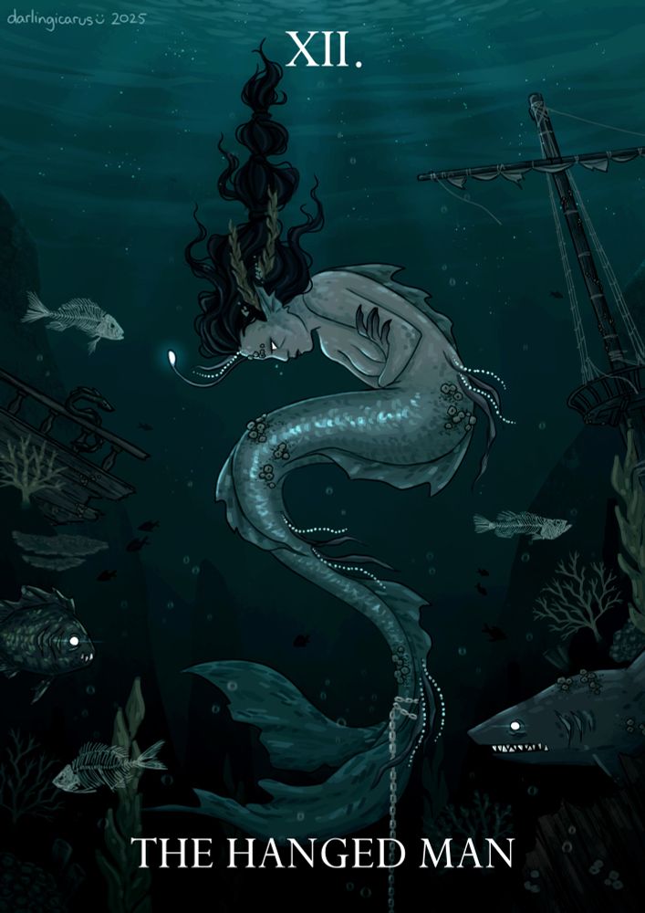 A digital tarot illustration depicting a mermaid chained to the sea floor, with the text "XII. The Hanged Man" overlaying the image. The mermaid has dull grey skin, a dull blue tail and long black hair that trails upwards towards the water's surface. In the middle of her forehead is a protruding tendril with a glowing orb at the end, similar to that of an angler fish. Her tail is covered in barnacles. She is curled into a fetal position with her arms folded over her stomach, a posture that reads as both defensive and frustrated when combined with her flat expression. A chain is tied around her tail and disappears into the darkness at the bottom of the page. Large rock faces rise out of the gloom on either side of the mermaid, framing her in pillars of stone. A decaying ship's mast can be seen on one side of the illustration, and a fragment of a ship's hull on the other. Coral and seaweed litter the environment, as well as several fish. One is an eerie-looking shark with its teeth bared. Another fish has fangs and a glowing white eye. There are three skeletal fish surrounding the mermaid as well, still swimming as if they were alive. The entire illustration is dim and gloomy, painted in shades of murky teal.