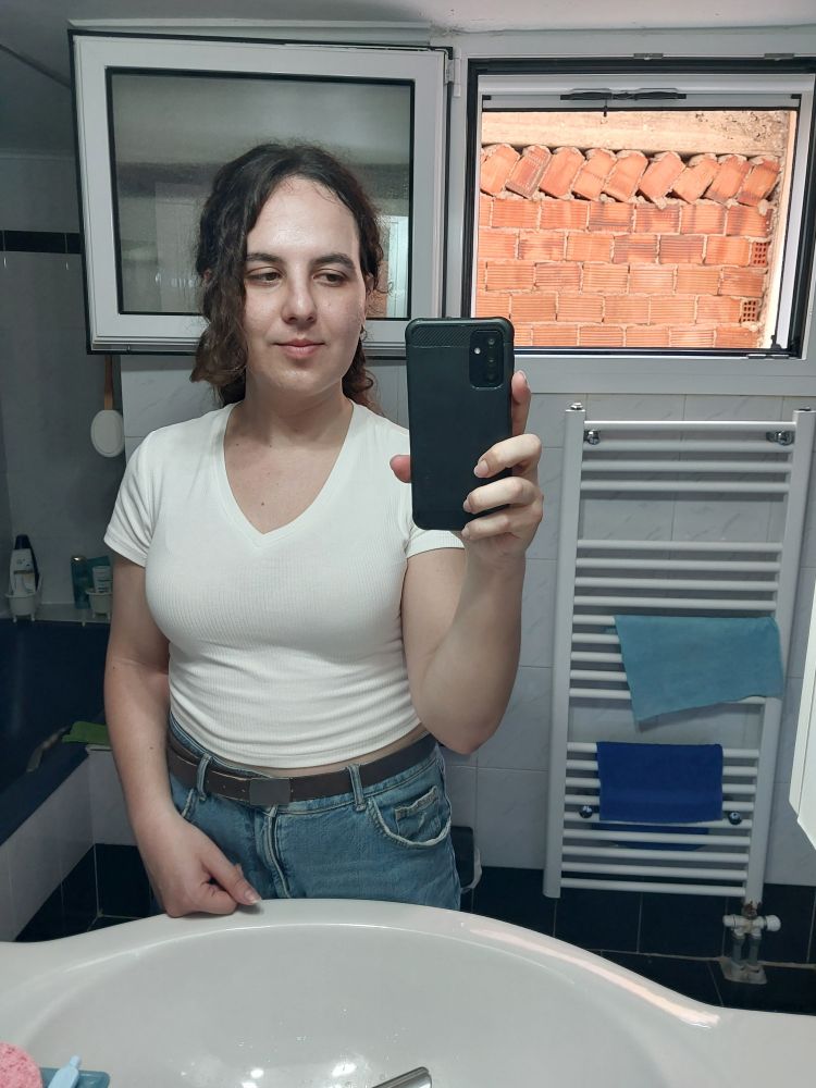 Woman posing in front of the bathroom mirror with her hair in a ponytail