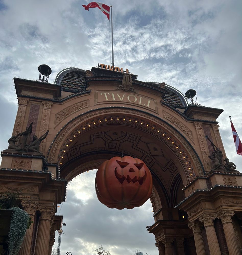 The entrance archway leading into Tivoli Gardens with a large model pumpkin hanging down. 
