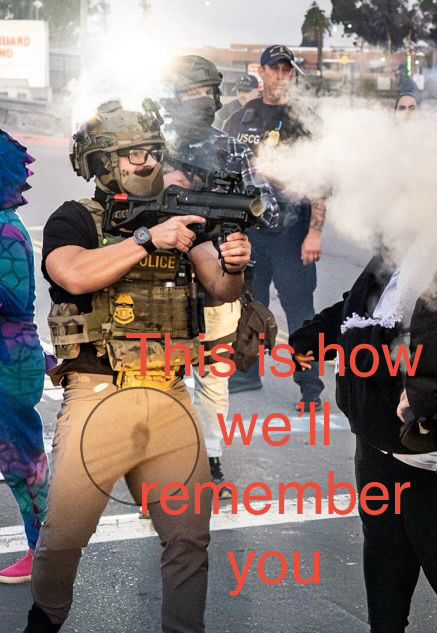 After officers set off two stun grenades, an officer blasted a riot control agent, likely a pepper-spray round, into the crowd, hitting Jorge Bautista, a pastor with the United Church of Christ in San Mateo, wearing all black at right, in the face. Credit: Jerome Parmer