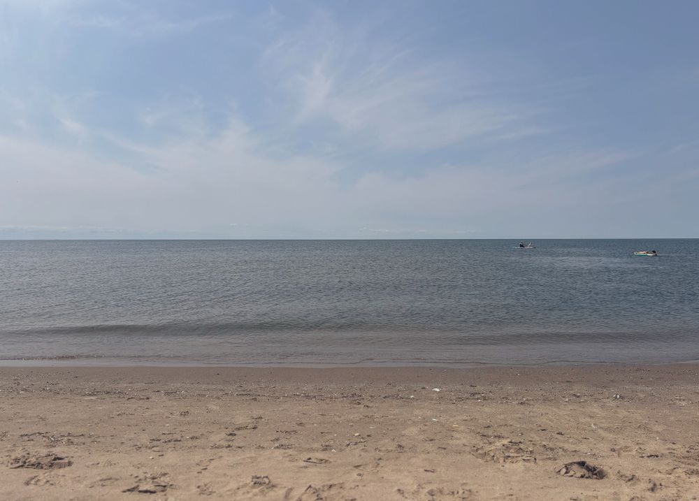 View of the lake from my shaded tent 😇 
Sand, water, horizon and blue skies