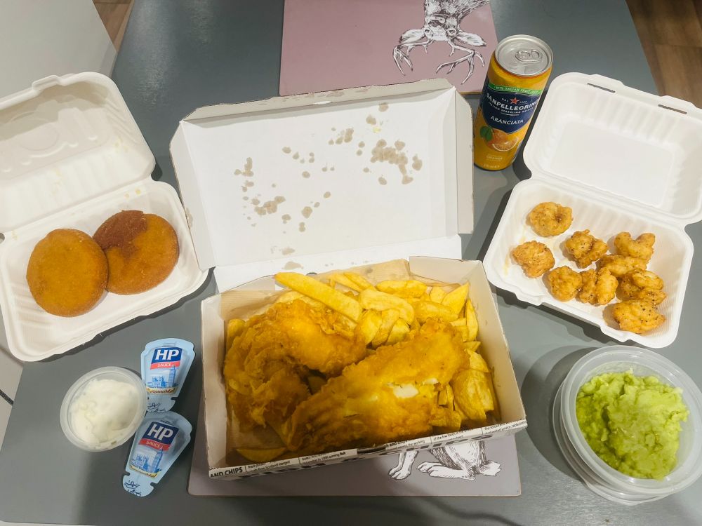 Battered cod, fish cakes, salt and pepper squid, chips, mushy peas, tartare and HP sauce, with a blood orange soft drink, all from the local chippy