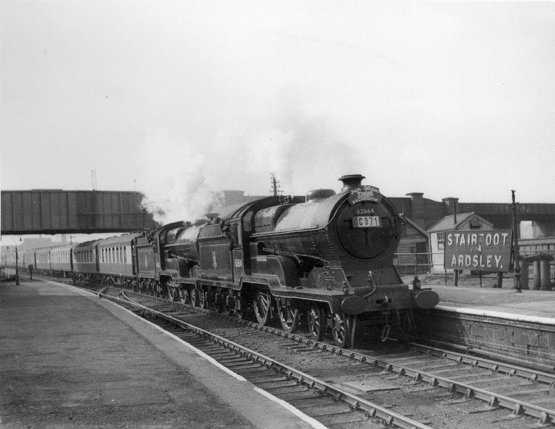 Locomotive number 62664 leading a double headed train made up of Pullman stock
