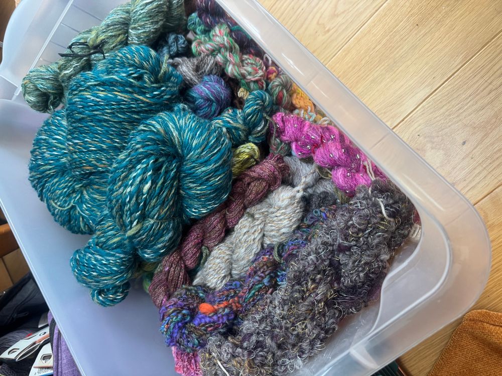 Plastic tub full of handspun yarns