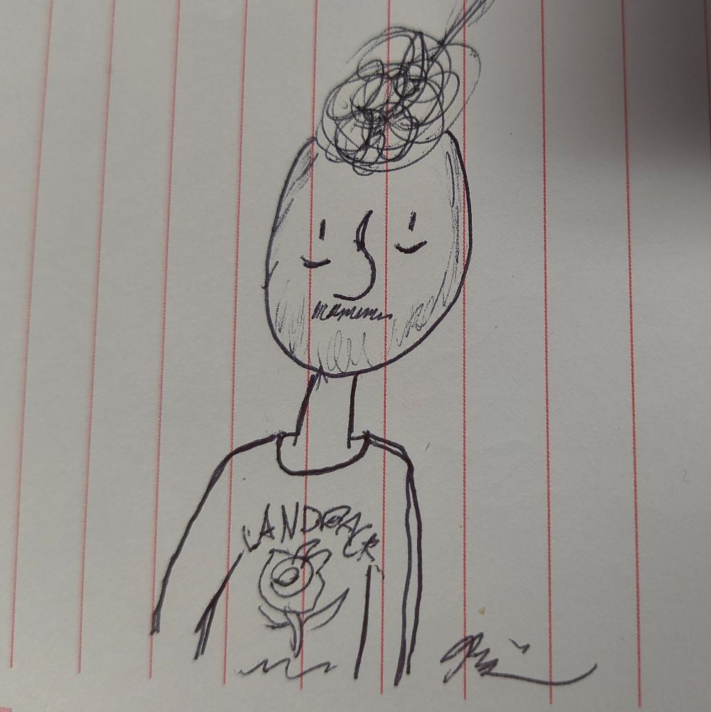 A pen drawing on a memo pad showing a simplified drawing of a very tired individual in a sweater with messy hair and a scraggly moustache 