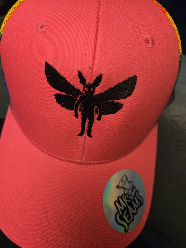 Hot pink trucker hat with an embroidered Mothman.