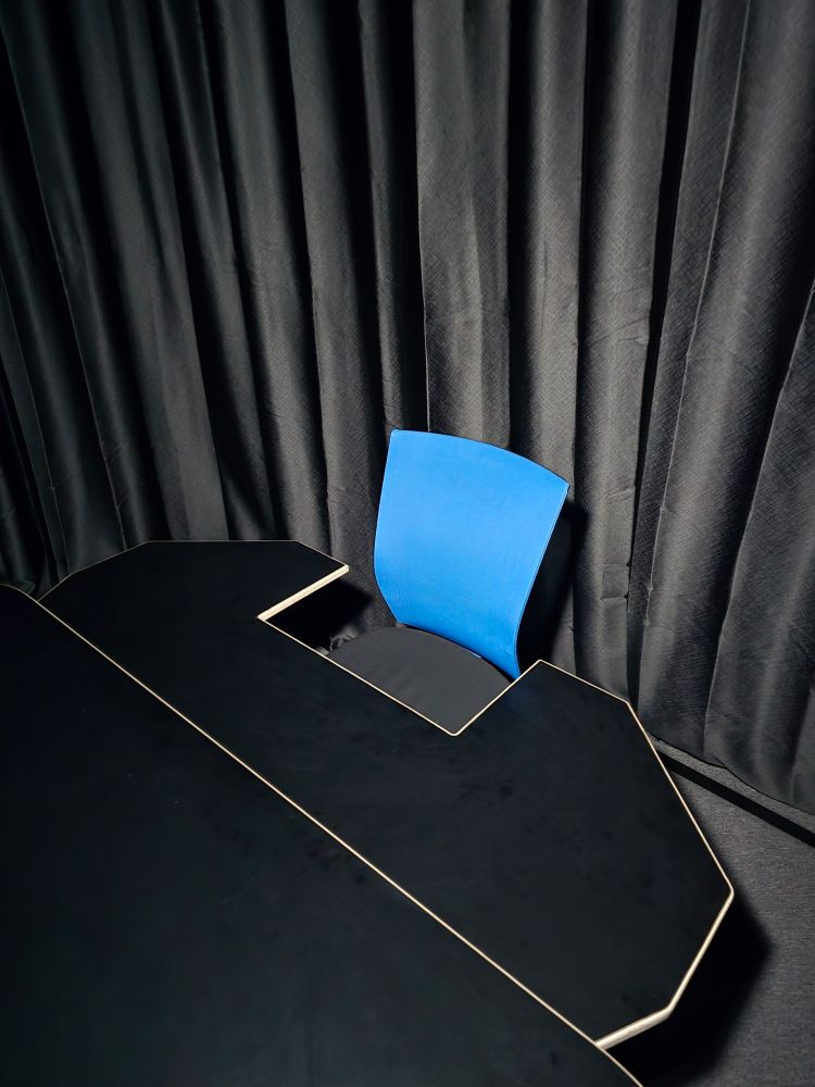 A U-shaped table oriented around a single office chair.