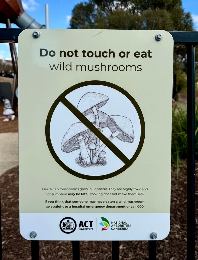 Sign reads, in part: Do not touch or eat wild mushrooms…  consumption may be fatal…”