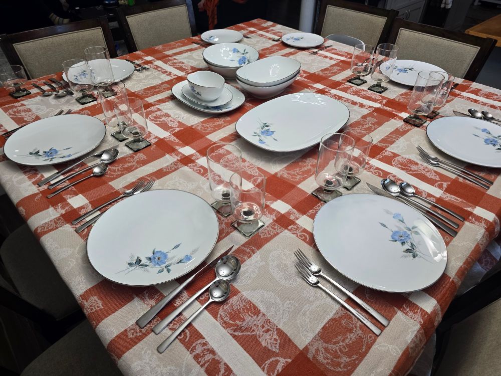 same table setting except now there is a orange and white fall themed tablecloth underneath all of it