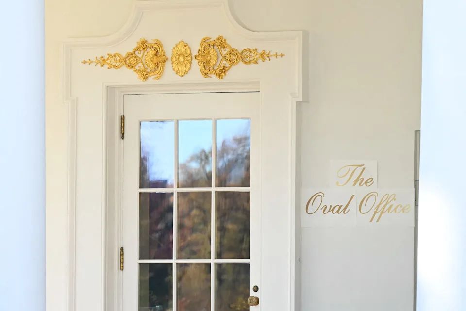 Closer view of the Oval Office sign and door brick a brack