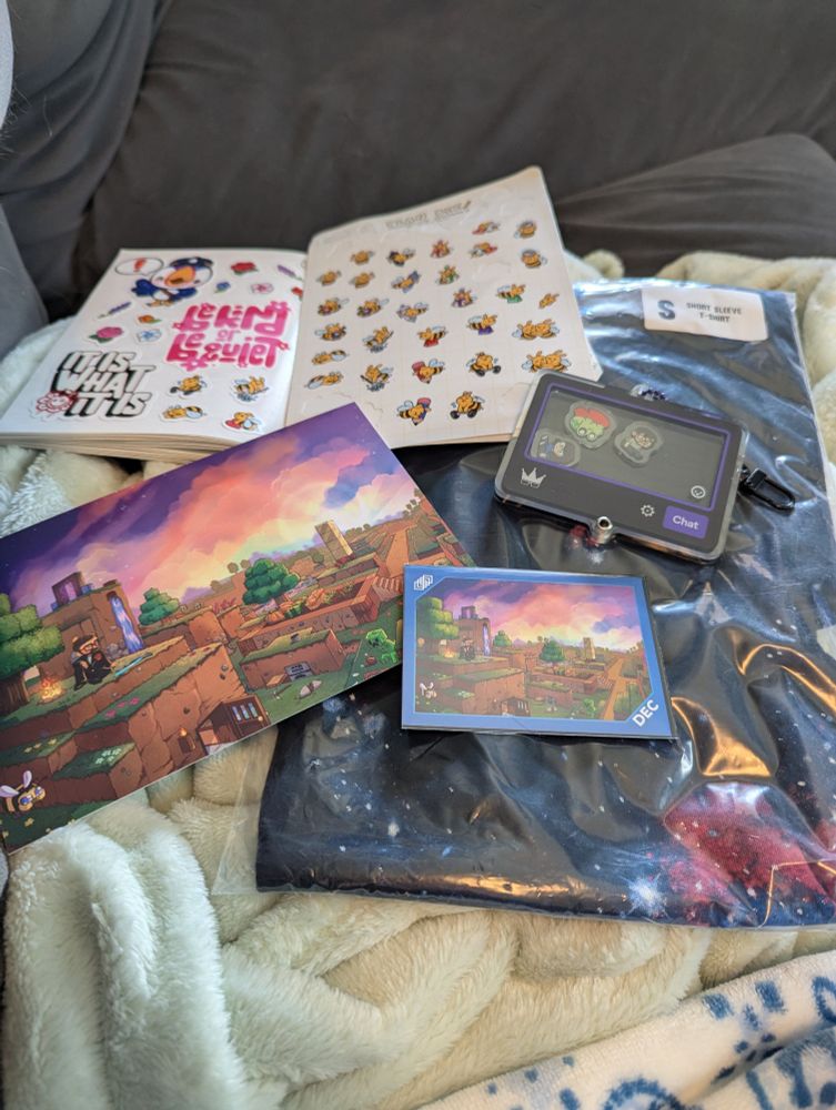 Collage of stickers, art print, trading card, shaker keychain, and still packaged t-shirt from FrameRate merch.