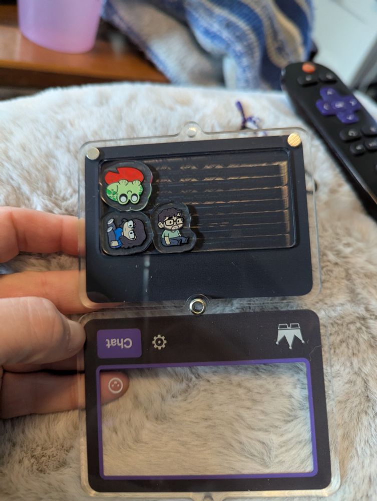 Inside of the shaker keychain featuring Ray, Tina, and the YouTube Frog emote.