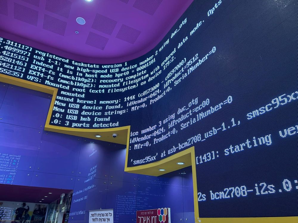 Lobby of a cinema where the large screen which is used to show clips and previews has crashed to an error screen.