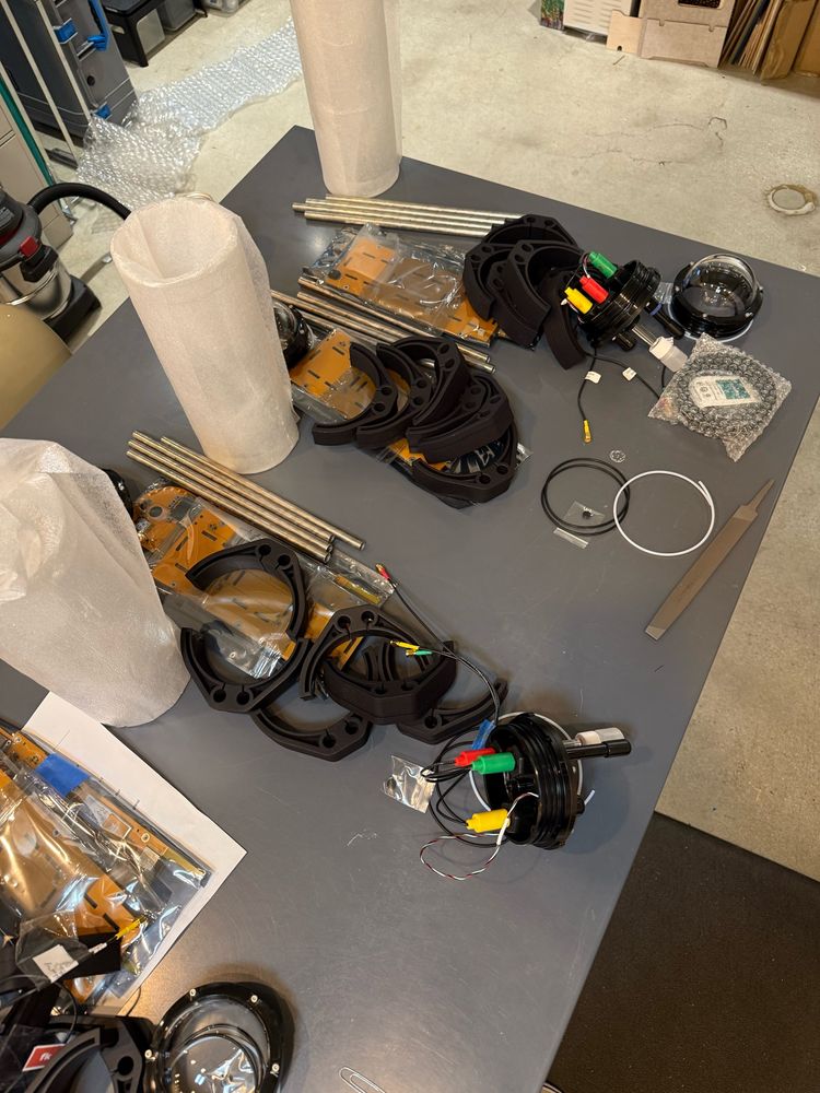 Unassembled parts for FieldKit.org underwater sensors sitting on a table. 