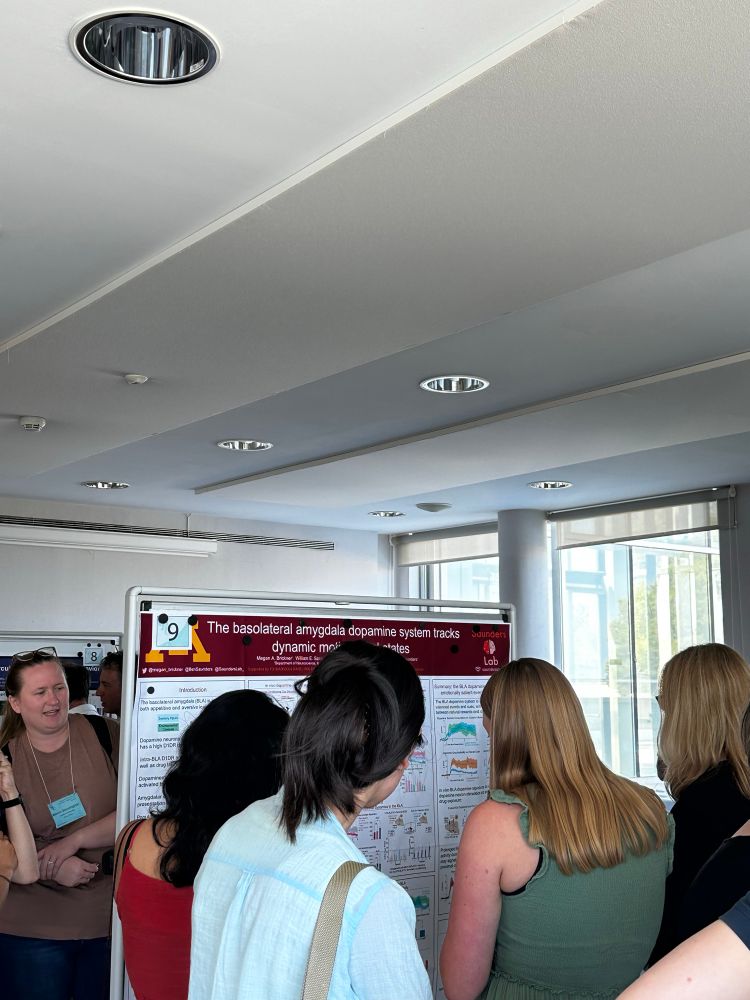 Group of scientists standing in front of a research poster