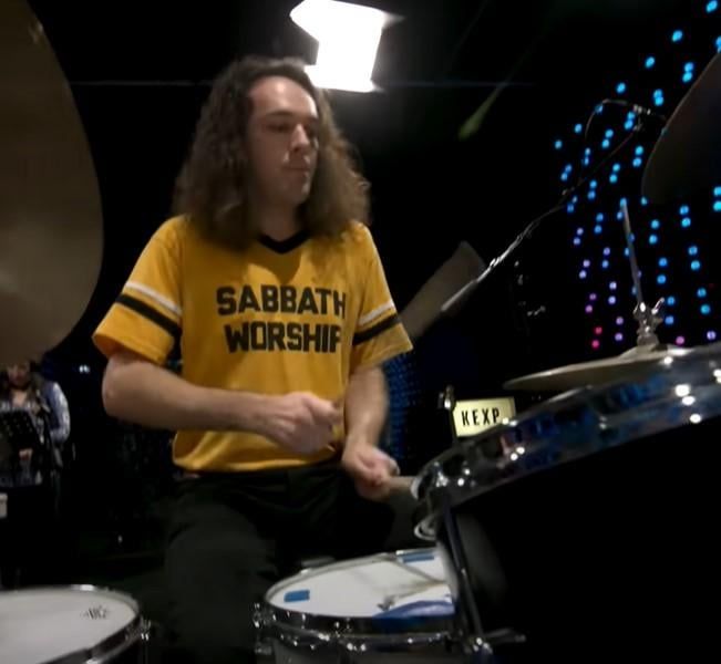 King Gizzard drummer Michael Cavanagh wearing a "Sabbath Worship" shirt