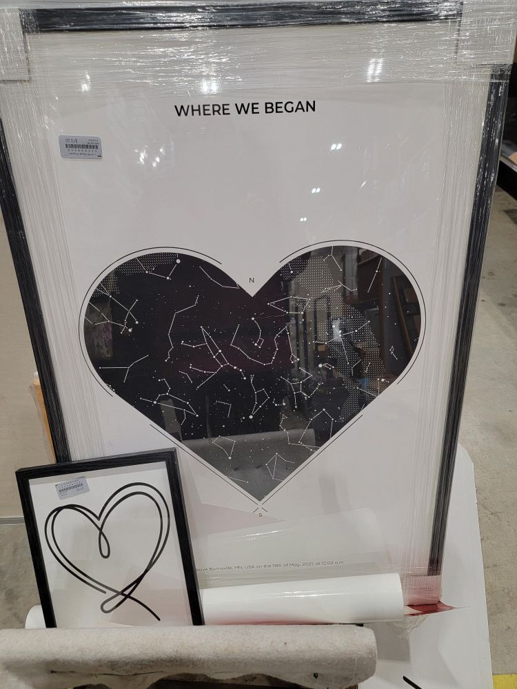 Two framed artwork pieces with black and white hearts