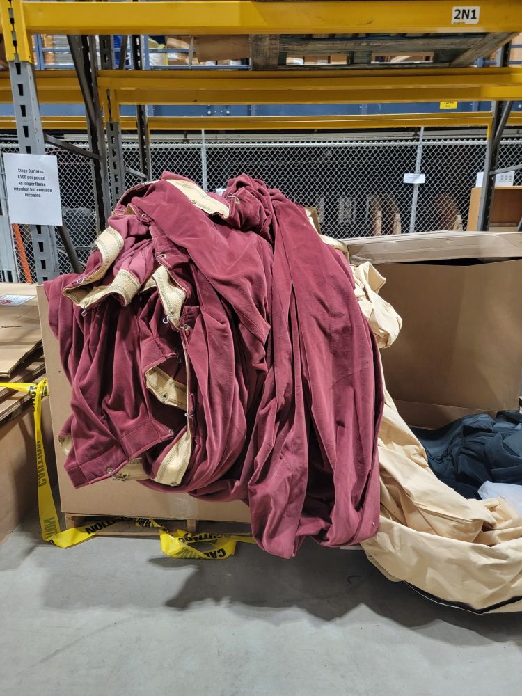 Box of red hued stage curtains. 