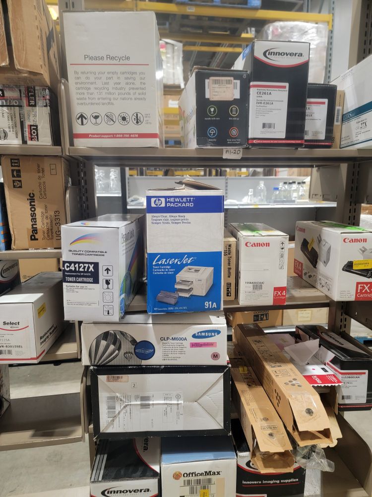 Shelves containing various sized boxes of ink and toner cartridges