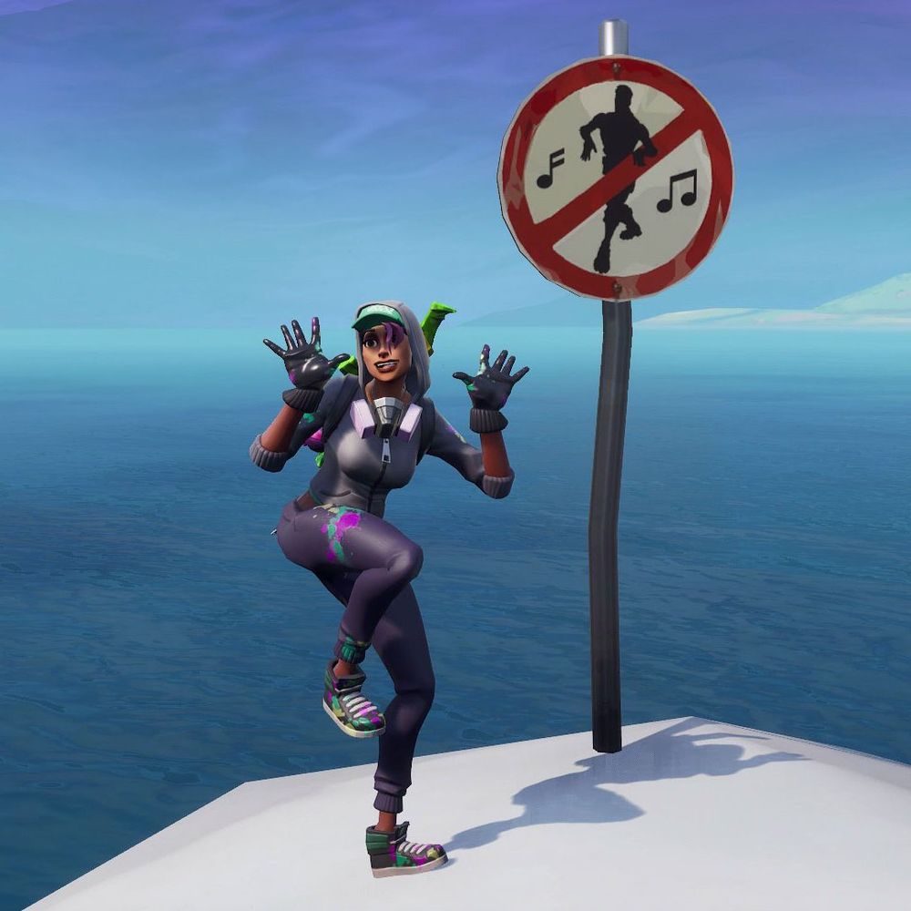 player in fortnite emoting in front of a "no emoting" sign