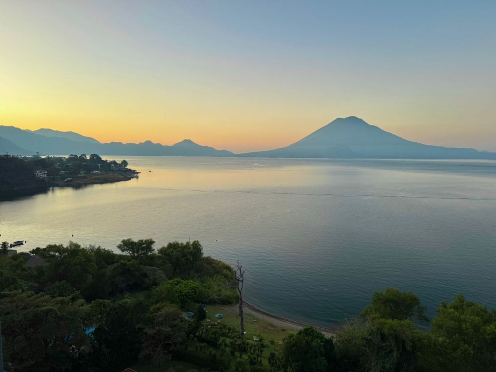 View of St Paul's volcano across Lake Atitlan at sunrise.