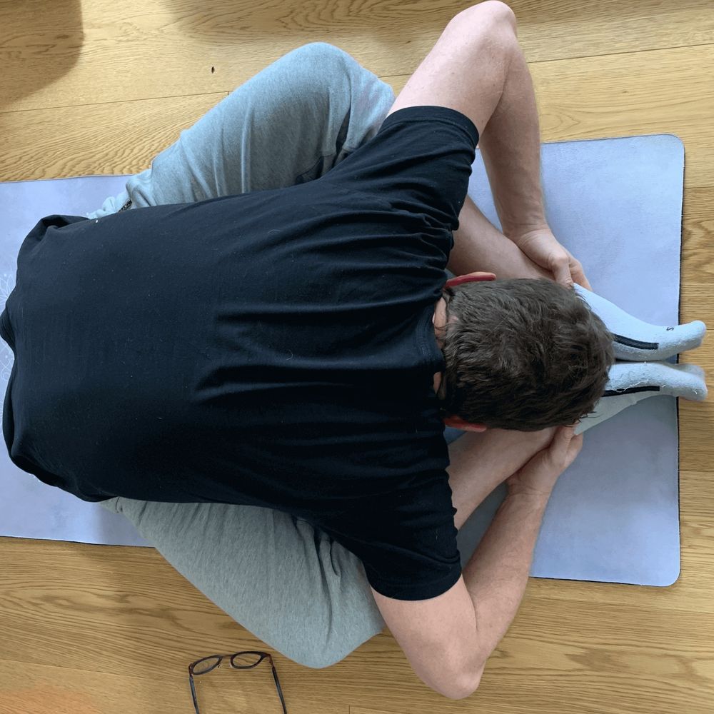 Yoga butterfly pose leaning forward.