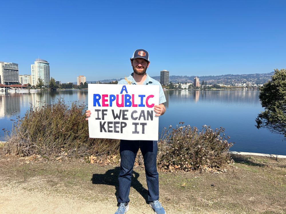 I’m standing in front of Lake Merritt holding a sign that says “A Republic if we can keep it”