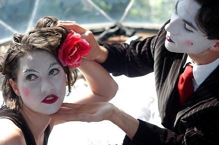 Amanda Palmer with a flower in her hair and in her harlequin makeup for a Dresden Dolls photo shoot 