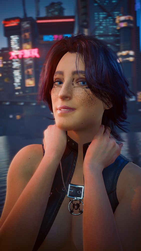 V from Cyberpunk 2077 smiles at the camera with the Night City skyline at her back. She's wearing a vest and her bullet necklace.