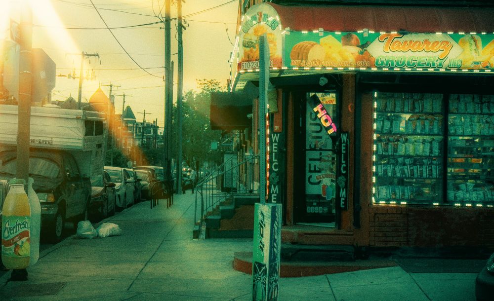 a bodega on the corner of a sunlit street