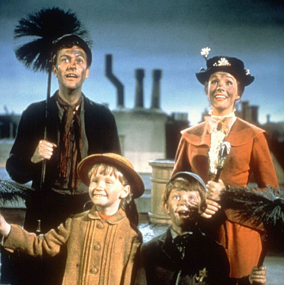 Still from Mary Poppins featuring Mary, the children and Bert the chimneysweep on a rooftop