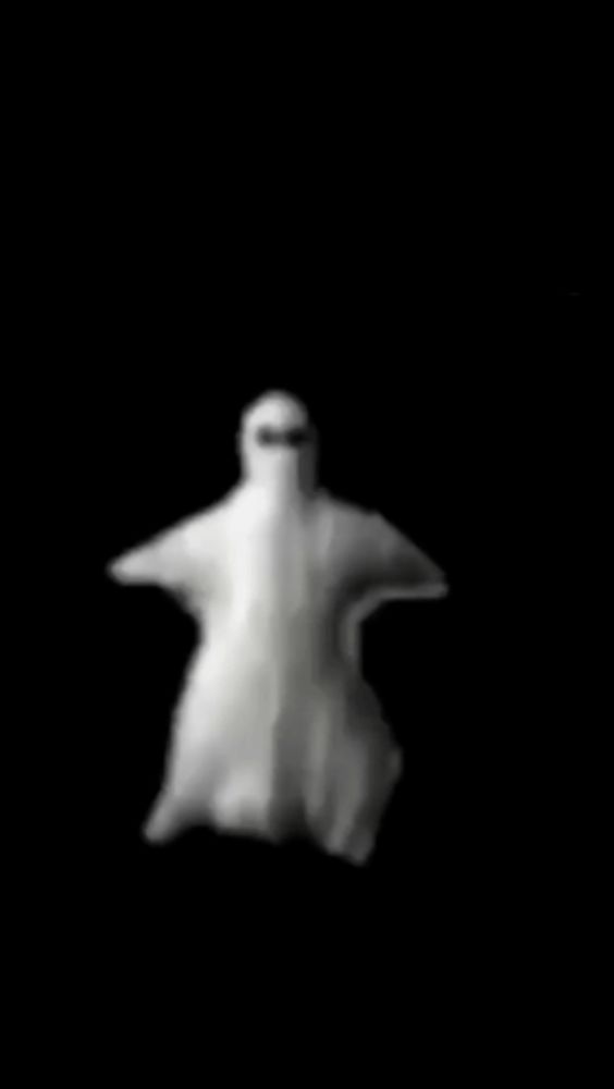 a ghost is flying through the air in a black background .