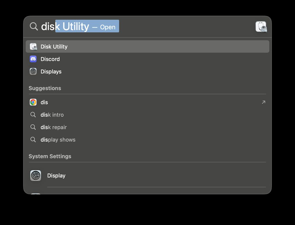 macOS's Spotlight application.  The search query is "dis" which Spotlight has autocompleted to "Disk Utility".  The second option in the menu is the Discord app.