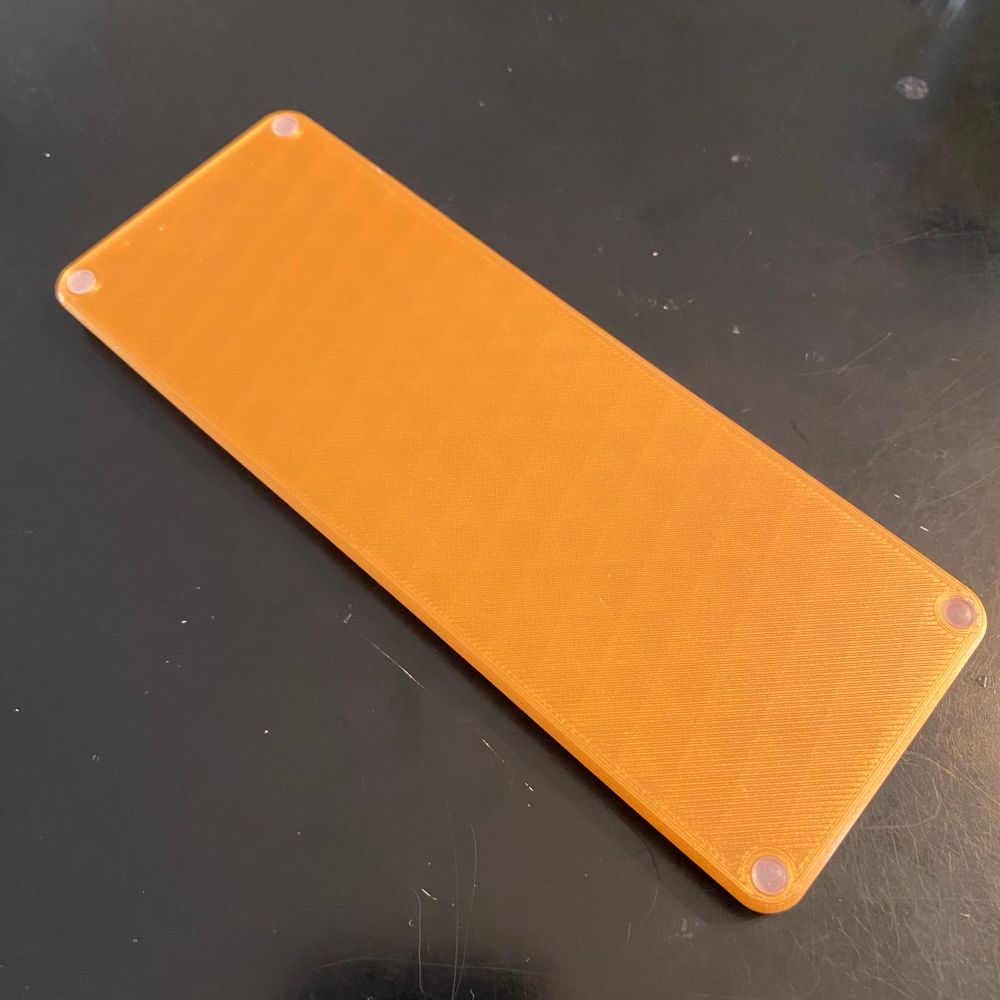 Bottom of the pen rest with tiny clear-white rubber dots in the corners.