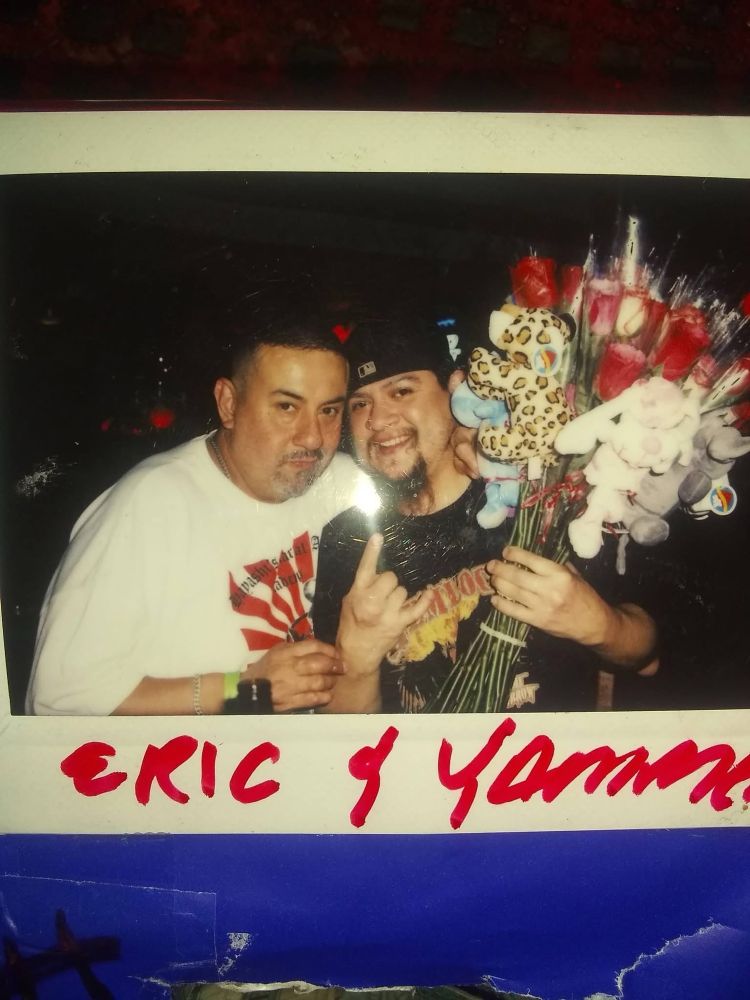 2 Latino men Eric $ Yammer. Yammer is holding bouquets of flowers and stuffed animals 