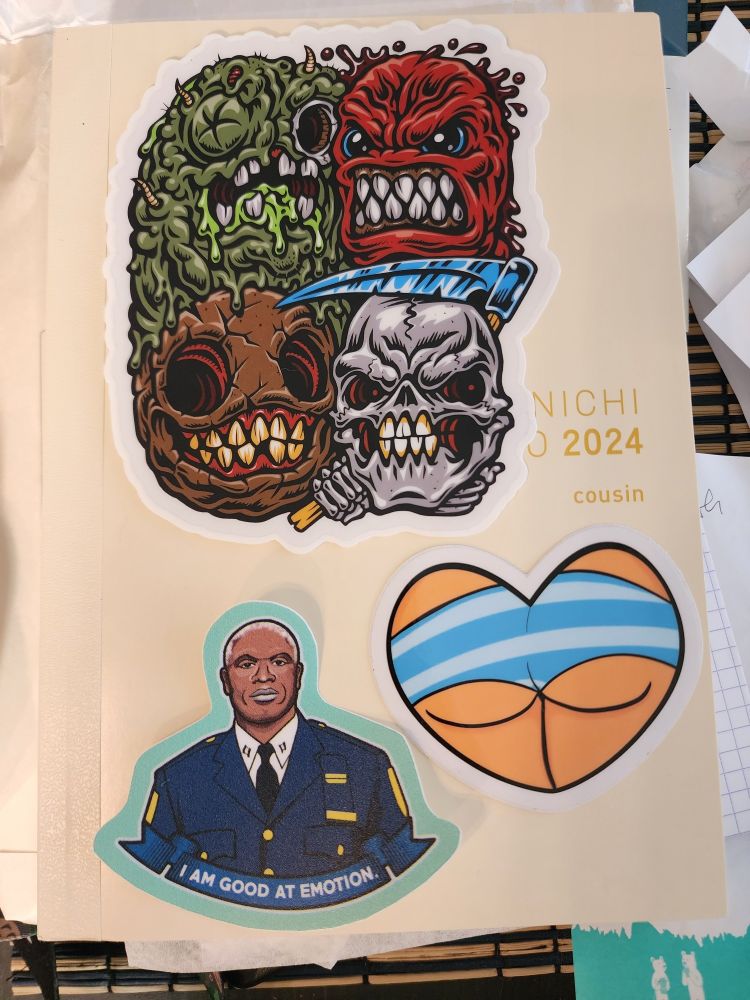 a hobonichi planner with arranged stickers on the front cover, Raymond Holt sticker says "I am good at emotion."