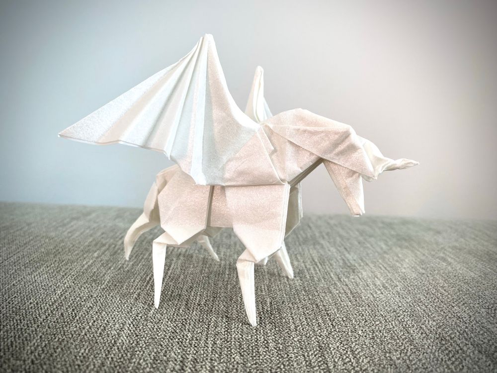 Origami Pegasus model folded with white tissue foil paper