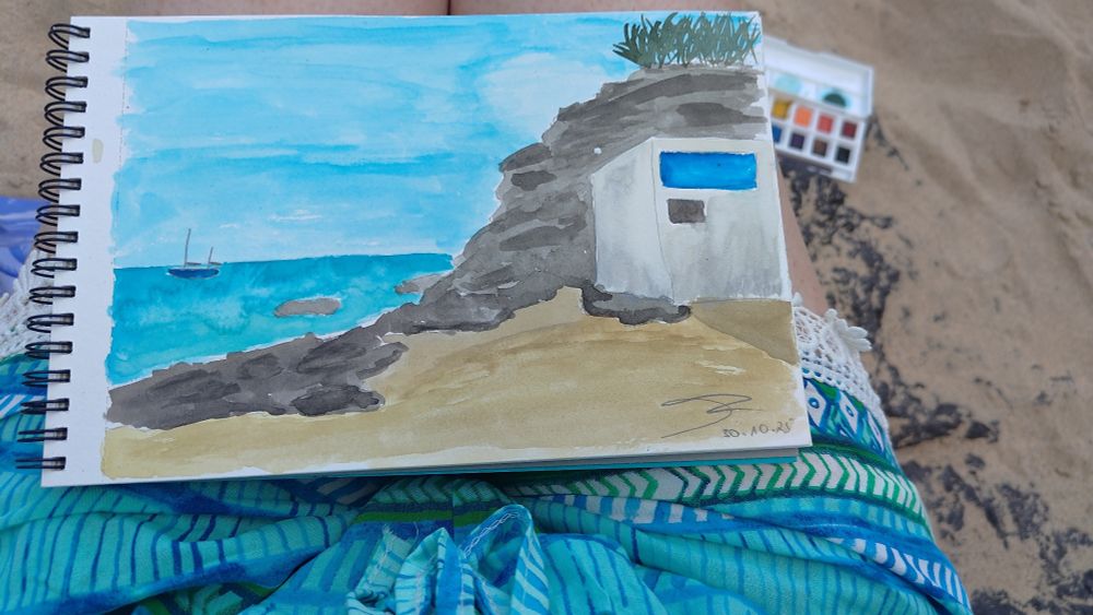 Photo of a watercolour painting of a landscape. It's a rocky cliff by the sea with a white building in the foreground and a sail boat near the horizon.