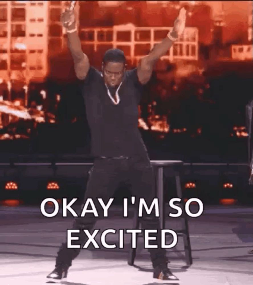 a man is dancing on a stage with his arms in the air and the words `` okay i 'm so excited '' .