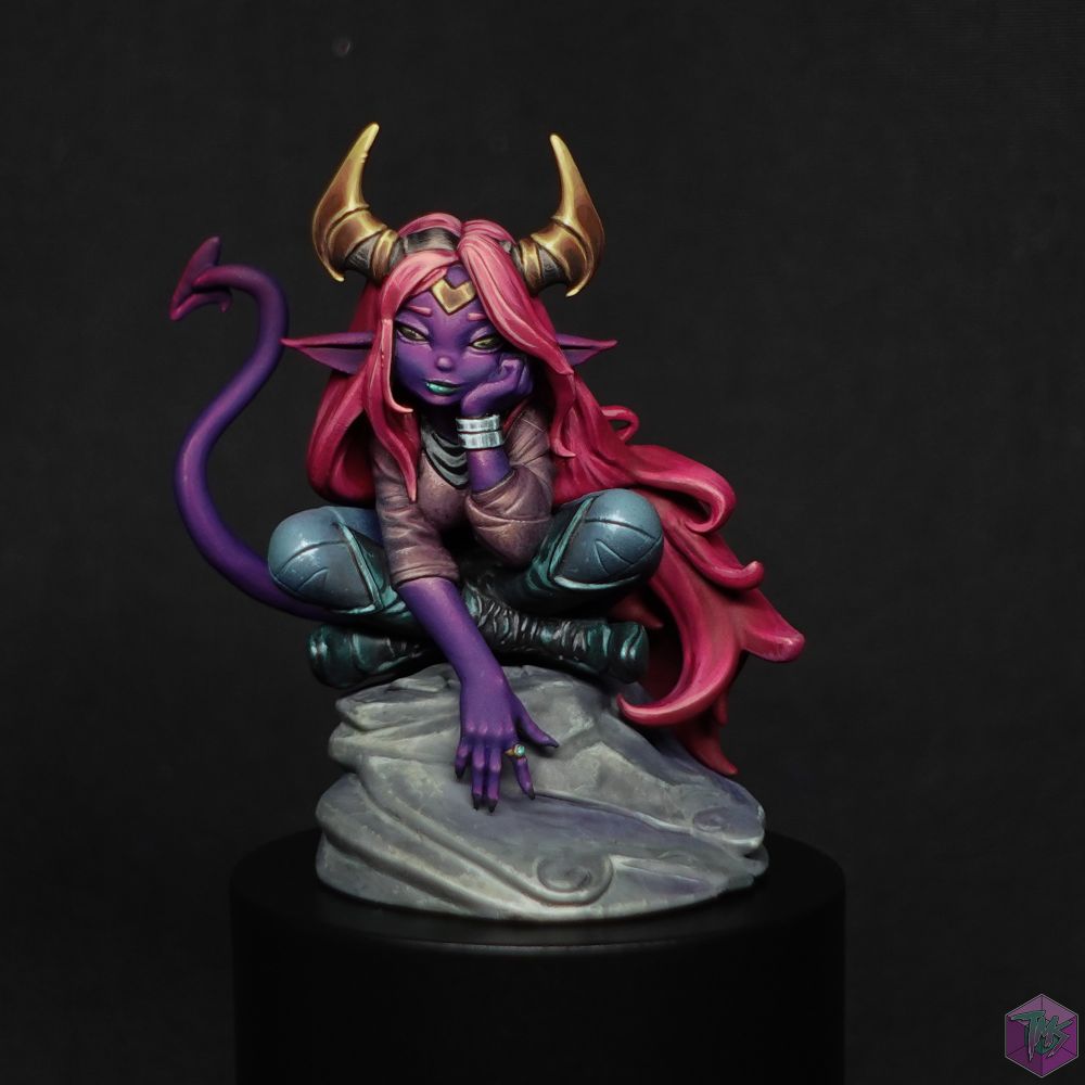 A purple skinned tiefling, sat on a rock.