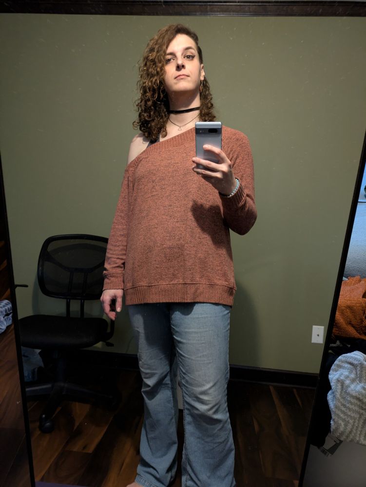 me in a burnt orange sweater with one shoulder cut out, and jeans. got a new haircut with an undercut on the left side :3