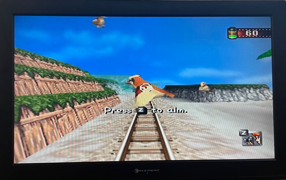 a pidgey flying across the track in the beach level